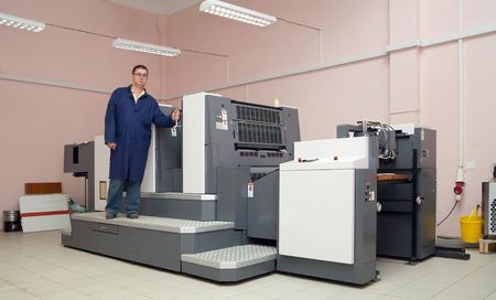 Printer working at his new offset machineの写真素材