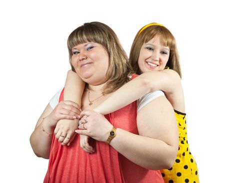 Two young happy girls over white backgroundの写真素材