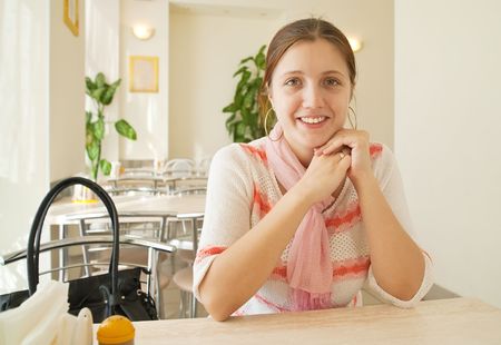 beauty brunette long-haired girl in coffee roomの写真素材