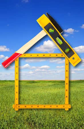 house concept build with tools over summer landscapeの写真素材