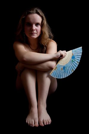 nudity girl with a fan on black. Isolatedの写真素材