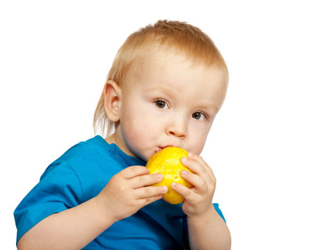 two-year boy in  blue shirt with pear, isolated on whiteの写真素材