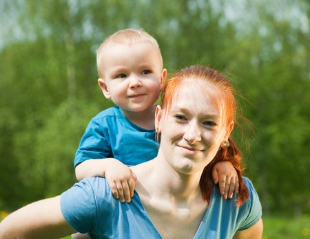 Happy mother with her son against natureの写真素材