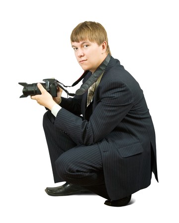 Young businessman with camera on white backgroundの写真素材