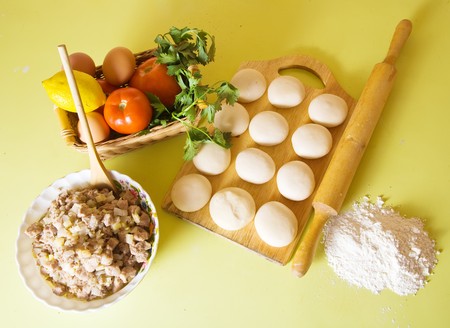 Ingridients for meat pasty at kitchen tableの写真素材