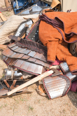knight clothing and weapon on ground during historical festival