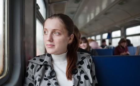 young female passenger sitting inside train  の写真素材