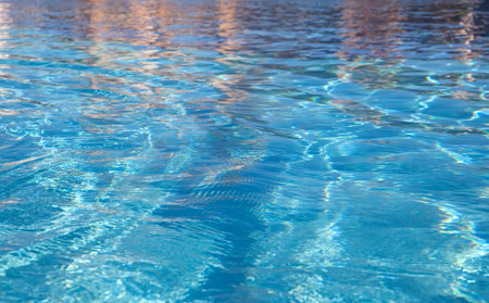 background of clean blue water in swimming pool at resort