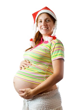 Pregnant woman in santa hat over whiteの写真素材