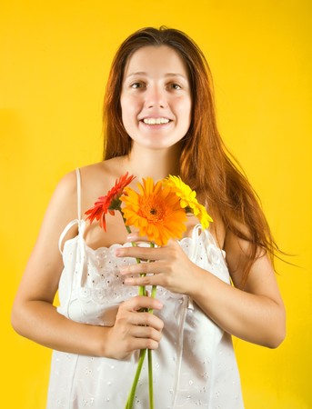 glamour portrait of pretty girl with  flowers over yellow backgroundの写真素材