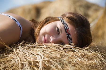 Beautiful girl enjoying the nature on a  hayの写真素材