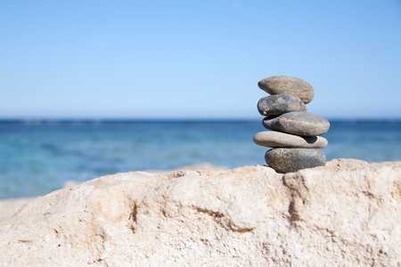 Pile of balanced stones on a beach の写真素材