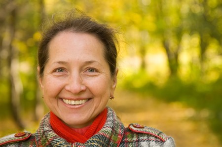 Portrait of mature woman  in autumn parkの写真素材