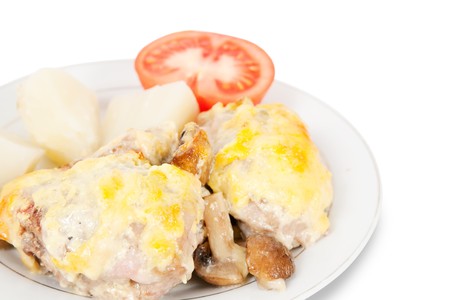 Closeup of  stewed chicken with mushrooms and cheese on plateの写真素材