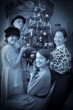 Retro photo of Family near Christmas tree at homeの写真素材