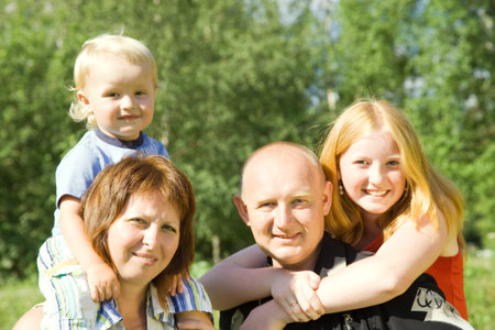 portrait of  happy family of four. Focus on parents