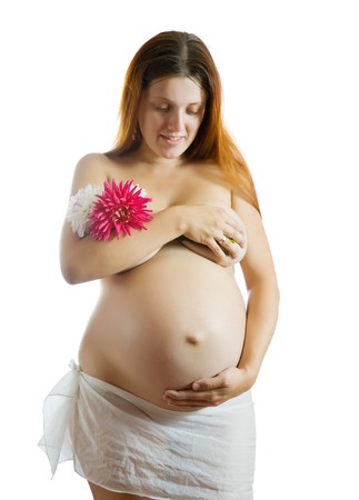 Portrait of 9 months nude pregnant woman with flower over whiteの写真素材