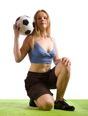Beautiful blonde girl posing with soccer ballの写真素材