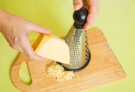 Closeup of cook grating cheese.
See in series stages of cooking of farci tomato の写真素材