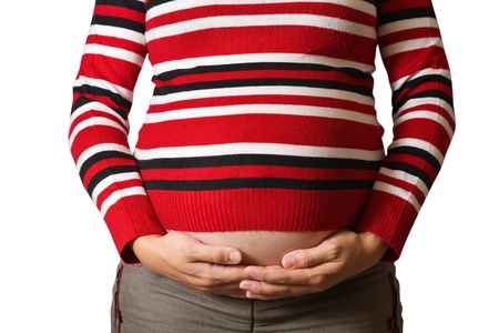 Belly of 9 months pregnant woman over whiteの写真素材