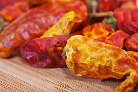 dried  red chilly pepper over wooden surface of table