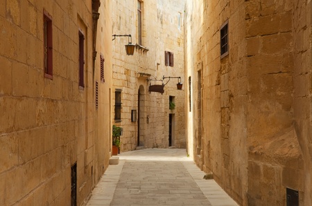 Old narrow  street of european town (Mdina, Malta)の写真素材