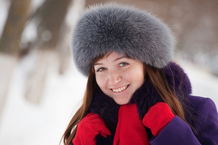 Portrait of beautiful woman in coat and fur capの写真素材
