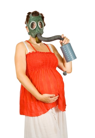 Portrait of  9 months pregnant woman in gas-mask over whiteの写真素材