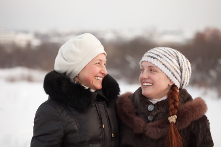 Portrait of two happy women in winter parkの写真素材