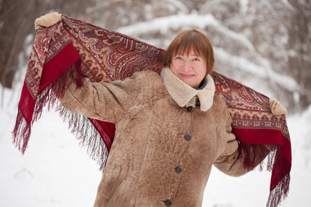 Happy mature woman with  babushka in winter の写真素材
