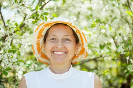 portrait of mature woman in the blossoming gardenの写真素材