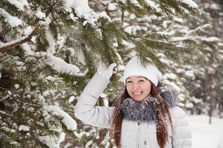 Portrait of  girl in wintry pine  forestの写真素材