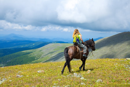 Female rider on horseback at mountains