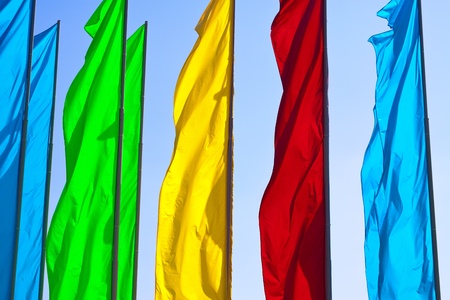 Colourful flags against the blue skyの写真素材