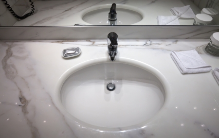 Marble sink in toilet with mirrorの写真素材