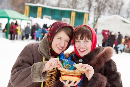 Women in traditional  clothes tasting pancake  during  Shrovetideの写真素材