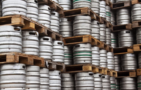 Many metal kegs of beer in regular rows