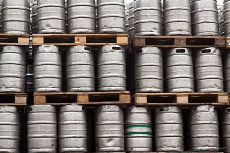 Many metal kegs of beer in regular rows