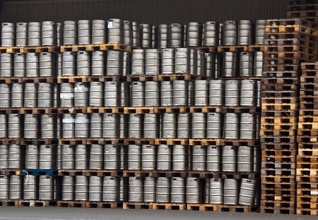 Many metal kegs of beer in regular rowsの写真素材