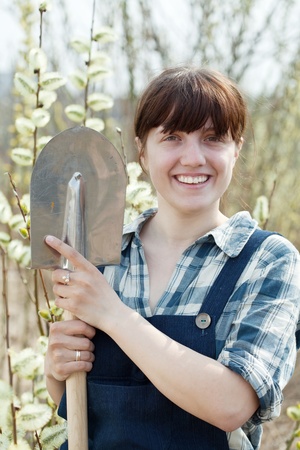Happy female farmer  with shovel in springの写真素材