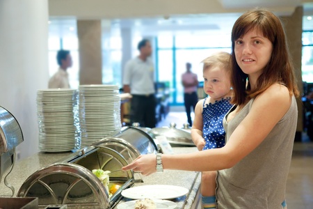 Mother with child  takes the meal  in hotel buffetのeditorial素材