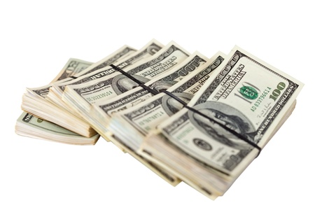 Many bundles of US dollars bank notes. Isolated on white backgroundの写真素材