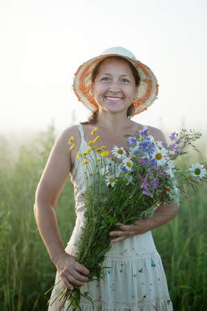 Outdoor portrait of   woman with flowers posyの写真素材