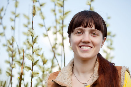 portrait of happy girl against spring  Willow branches with buds