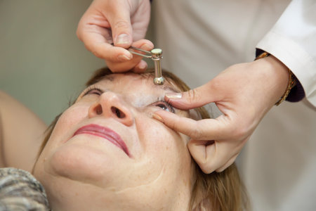 Ophthalmologist measures the  ocular tension in patients