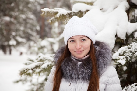 Portrait of  girl in wintry pine  forestの写真素材