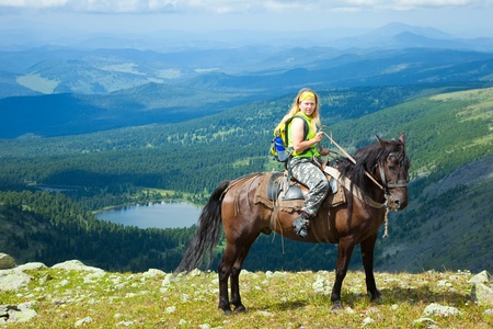 Female rider on horseback at mountains. Karakol lakes, Altaiの写真素材