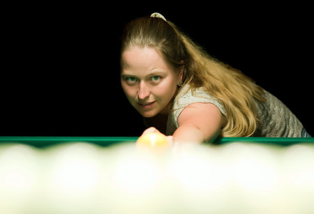 Casual dressed woman plays russian billiards