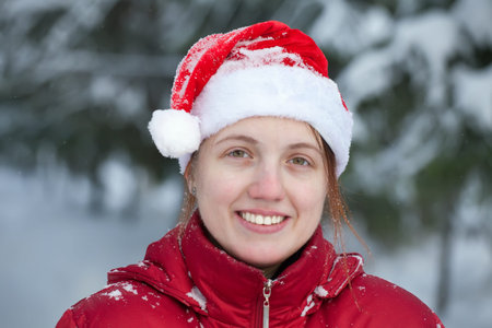 beautiful woman in Santa hat at winter park