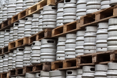 Many metal kegs of beer in regular rowsの写真素材